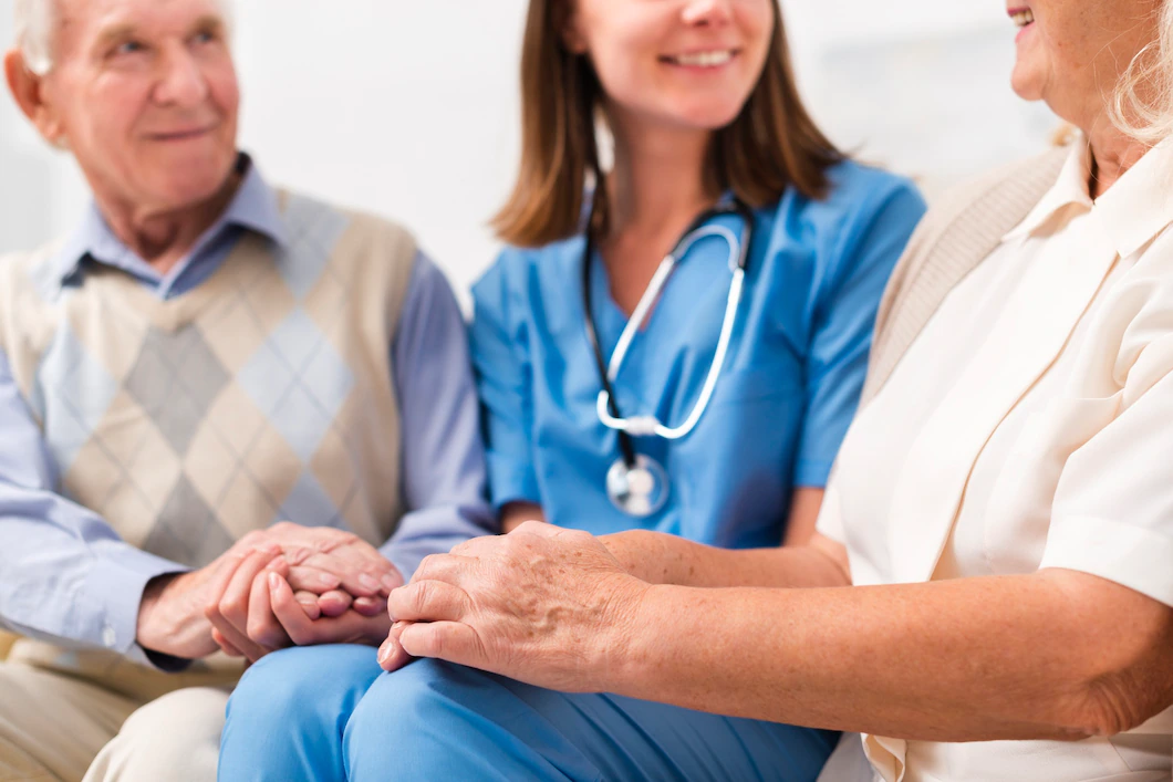 old-man-woman-sitting-yellow-sofa-with-nurse_23-2148238969